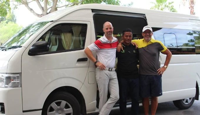 VIP golf transfer minivan outside Phuket hotel picking up golfers for early morning tee time at championship course Thailand